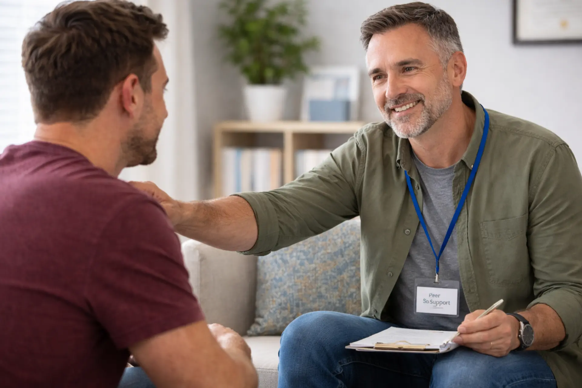 Certified peer recovery specialist mentoring a patient at an addiction treatment center in Pontiac, Michigan.